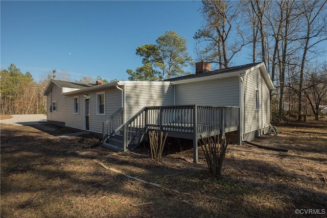 rear view of property with a wooden deck