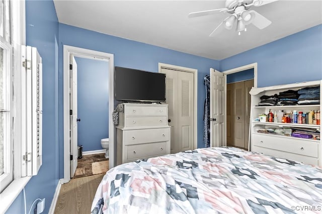 bedroom featuring connected bathroom, ceiling fan, and light hardwood / wood-style flooring