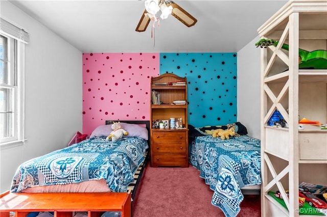 bedroom with ceiling fan, carpet floors, and multiple windows