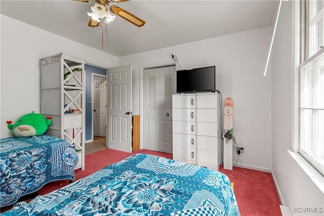 carpeted bedroom featuring ceiling fan and a closet