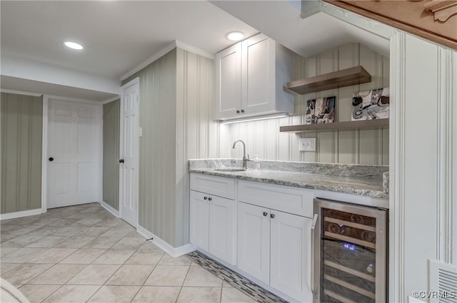 bar featuring wine cooler, light tile patterned floors, recessed lighting, a sink, and baseboards