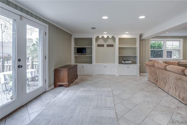 unfurnished living room featuring built in shelves, light tile patterned flooring, visible vents, and recessed lighting