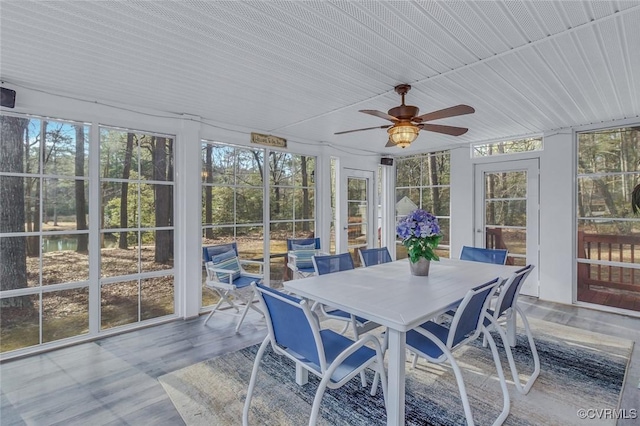 sunroom / solarium featuring ceiling fan