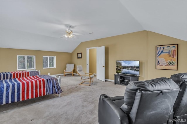 carpeted bedroom with ceiling fan and vaulted ceiling