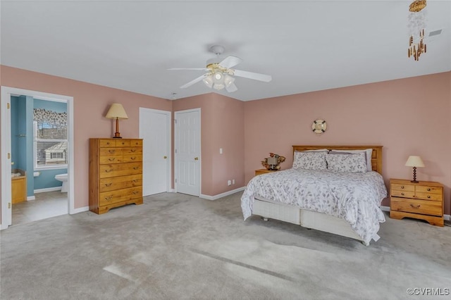 bedroom with carpet floors, ceiling fan, and ensuite bathroom