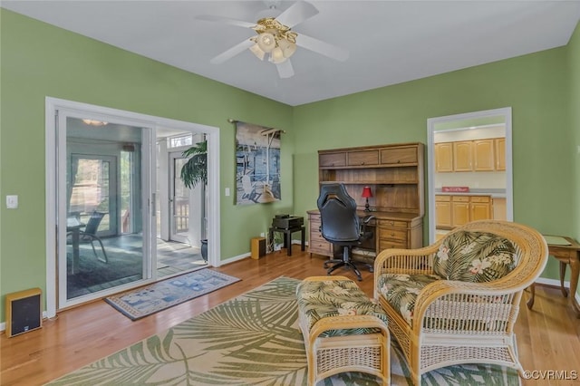 sitting room with light hardwood / wood-style flooring and ceiling fan