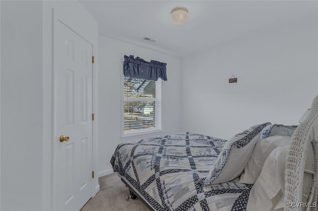 bedroom featuring light carpet