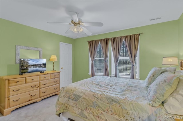 bedroom featuring ceiling fan and light carpet