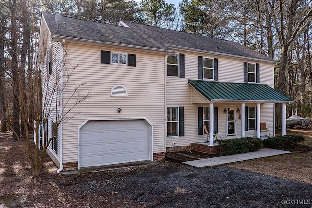 view of front facade with a garage and covered porch