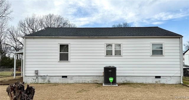 view of side of home with a yard and cooling unit