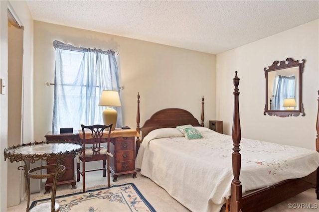bedroom with a textured ceiling and light carpet