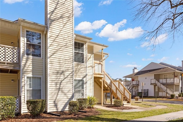 view of property with stairs and a residential view