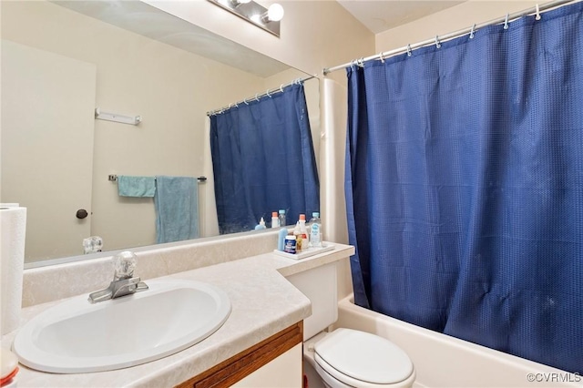 bathroom with vanity, shower / bath combo with shower curtain, and toilet