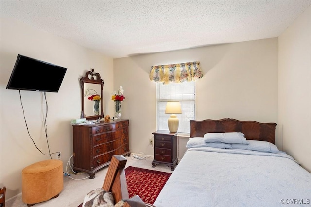 carpeted bedroom featuring a textured ceiling