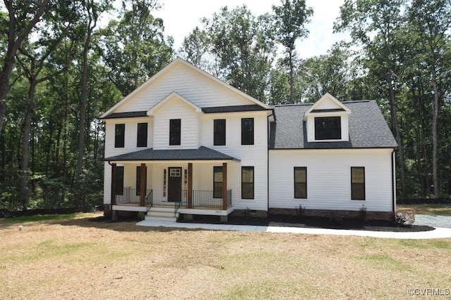 view of front facade with covered porch and a front lawn