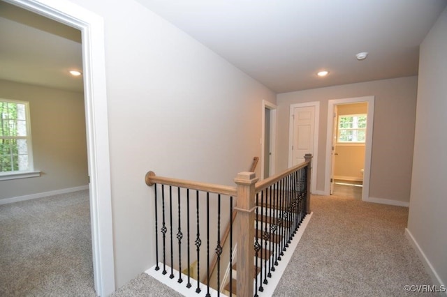 hallway with light colored carpet