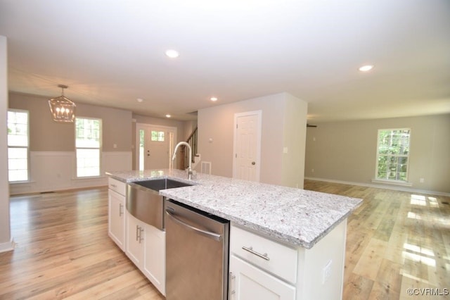 kitchen featuring sink, light hardwood / wood-style flooring, a center island with sink, dishwasher, and white cabinets