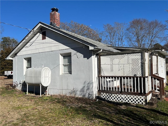 view of property exterior with a yard