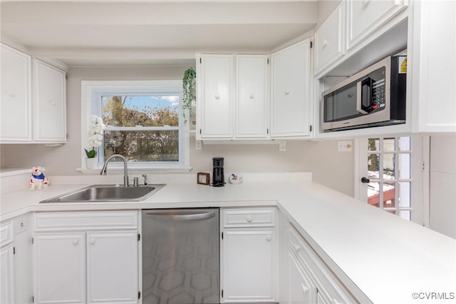 kitchen featuring stainless steel appliances, sink, and white cabinets