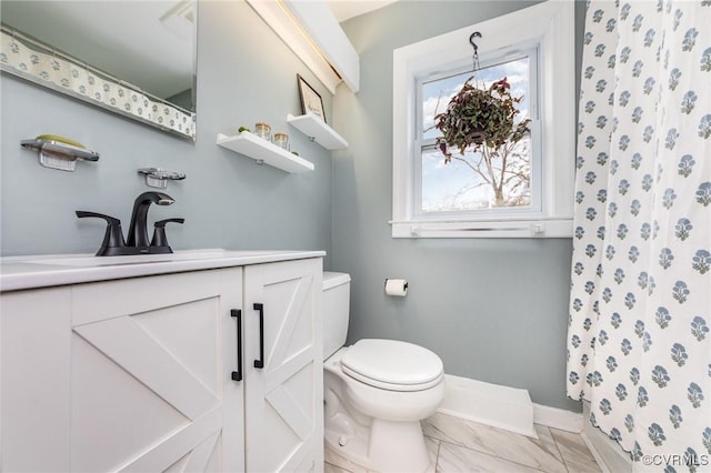 bathroom with vanity, toilet, and a shower with shower curtain