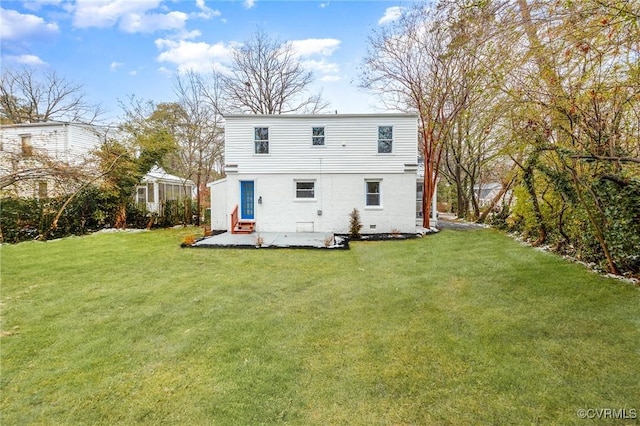 back of house featuring a lawn and a patio