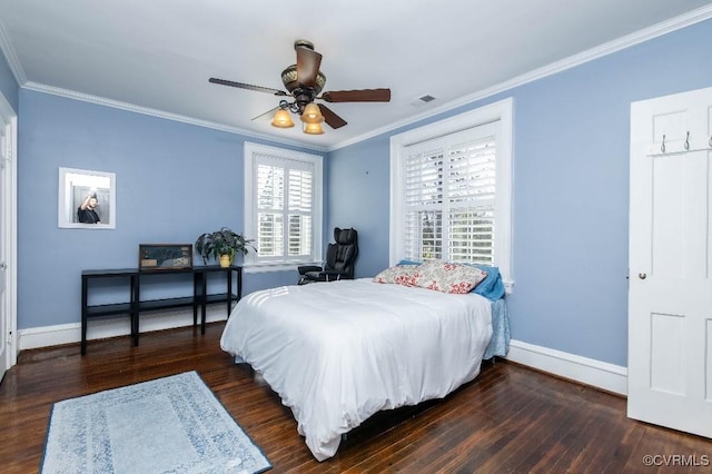 bedroom featuring ornamental molding, dark wood-type flooring, and ceiling fan