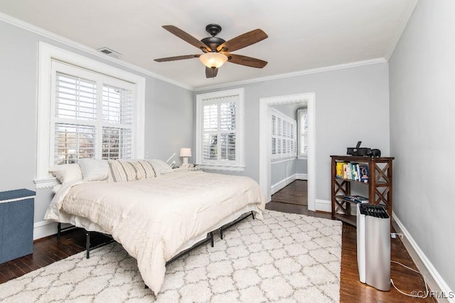 bedroom with dark wood-type flooring, ceiling fan, and ornamental molding