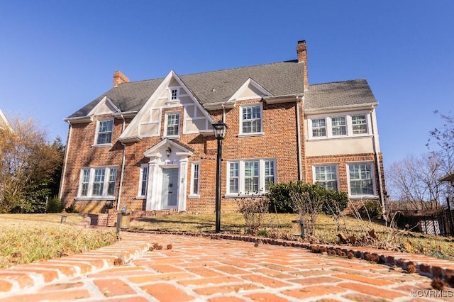 tudor-style house with a patio