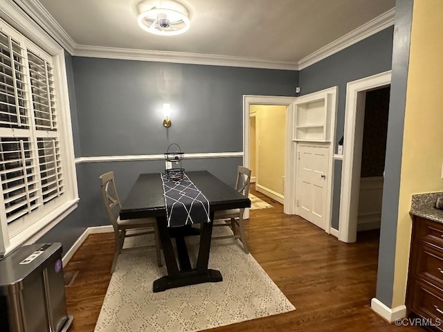 dining area featuring dark wood-type flooring and ornamental molding