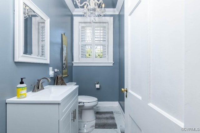 bathroom with vanity, crown molding, and toilet