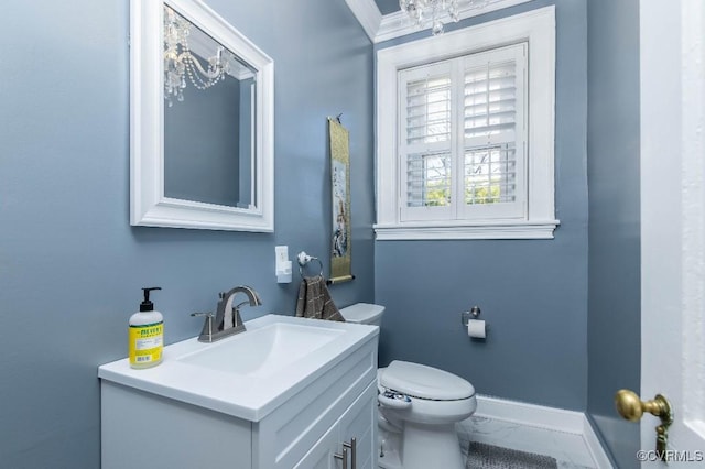 bathroom with crown molding, vanity, and toilet