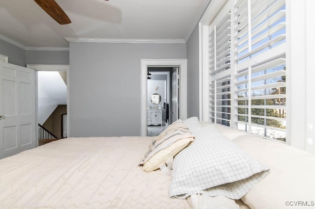 bedroom with ornamental molding, ceiling fan, and ensuite bath