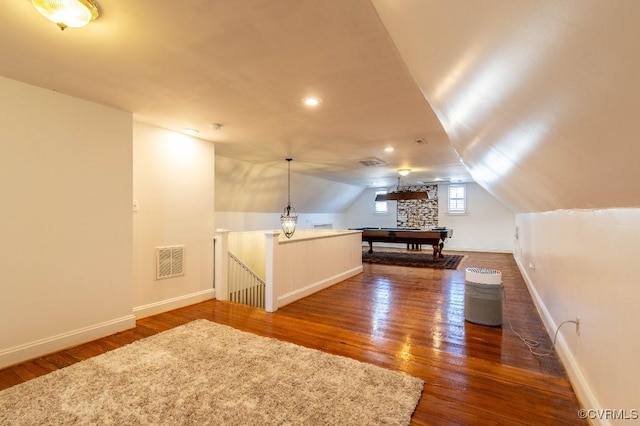 additional living space featuring dark hardwood / wood-style flooring, pool table, and vaulted ceiling