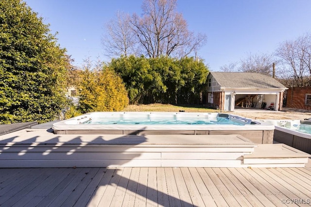 view of swimming pool featuring a wooden deck and an outdoor structure