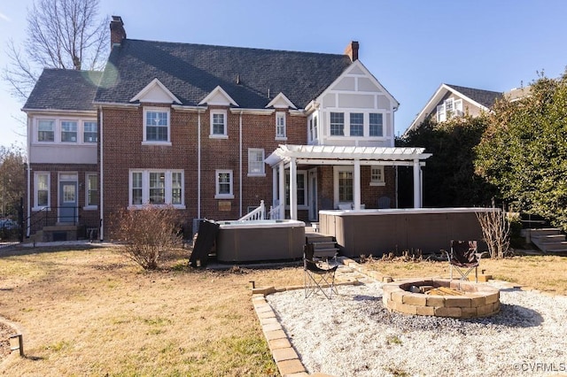 view of front of home with a hot tub, a fire pit, and a pergola