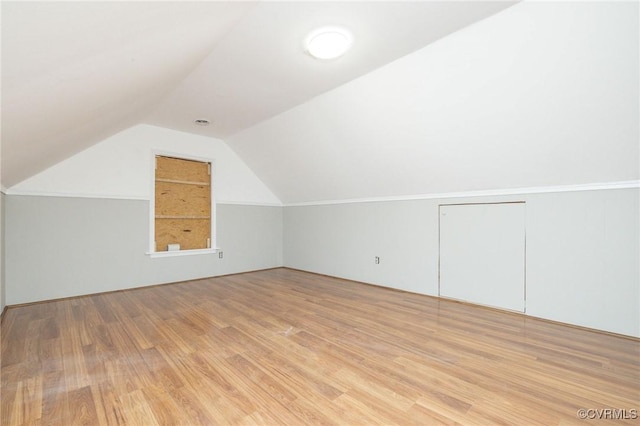 bonus room featuring lofted ceiling and wood finished floors