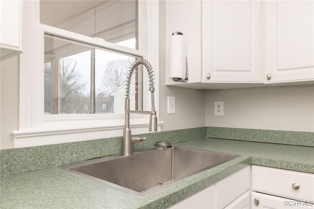 kitchen with white cabinetry and a sink