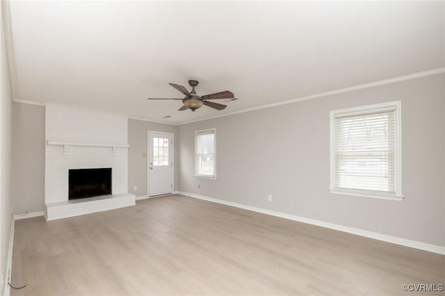 unfurnished living room featuring a ceiling fan, light wood-style flooring, ornamental molding, and baseboards