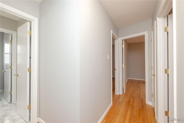 hallway featuring baseboards