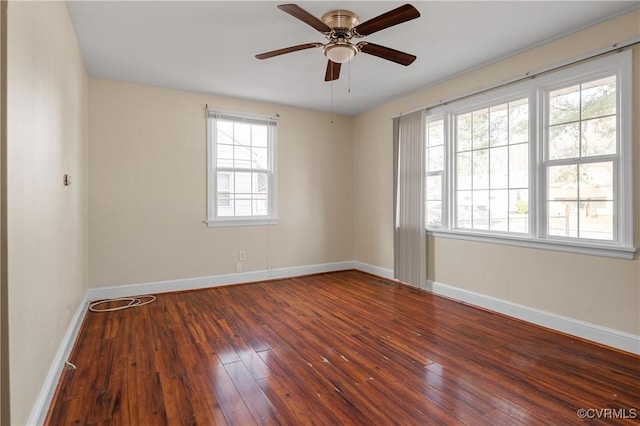 empty room featuring dark hardwood / wood-style floors and ceiling fan