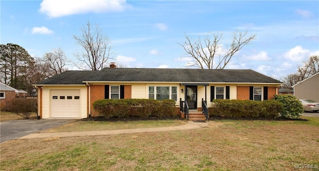 single story home with aphalt driveway, brick siding, a chimney, an attached garage, and a front lawn