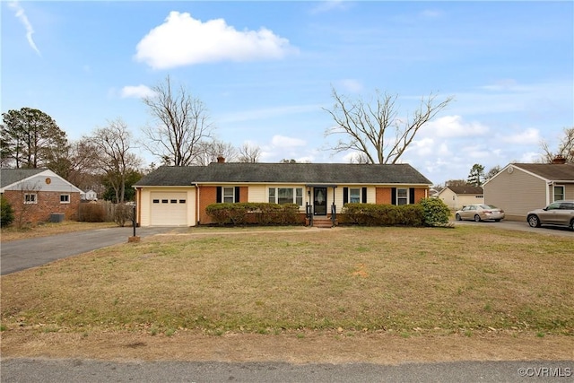 ranch-style house featuring an attached garage, brick siding, driveway, and a front lawn