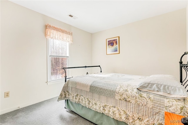 bedroom with carpet floors, baseboards, and visible vents