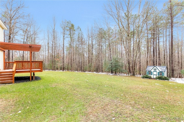 view of yard featuring a deck and an outbuilding