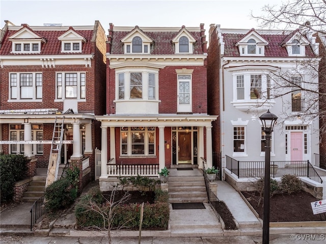 townhome / multi-family property with covered porch