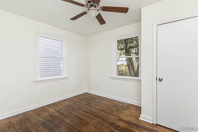 unfurnished room with dark wood-type flooring and ceiling fan