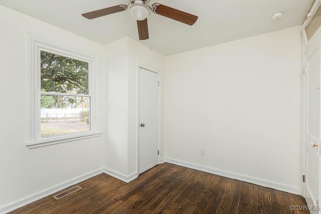 unfurnished bedroom featuring ceiling fan and dark hardwood / wood-style flooring