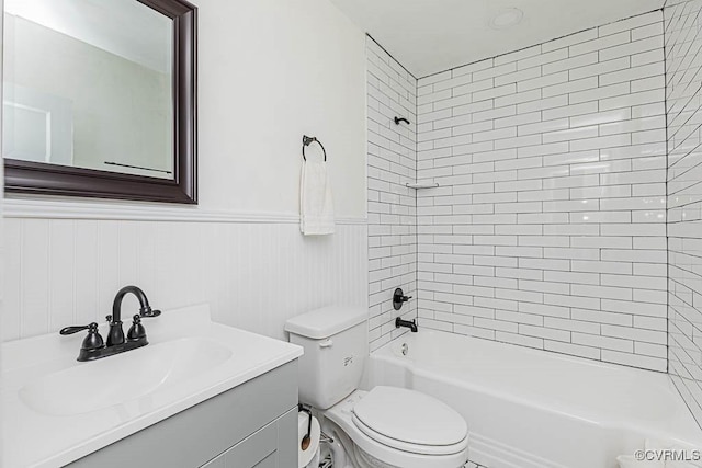 full bathroom with tiled shower / bath combo, vanity, and toilet