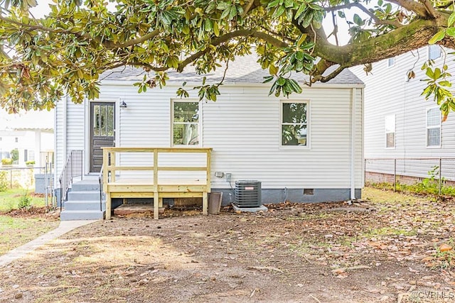 rear view of house with a wooden deck and central AC unit