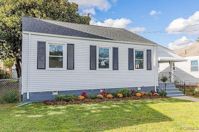 view of side of home featuring a lawn